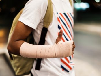 a man wearing a cast on his arm